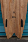 A close-up of the futures fin slots and scalloped fish tail also shows the bizia brand logo and albizia project certification. 