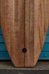 A close-up of the front of the wooden board's squash tail shows the leesh plug and pressure vent.