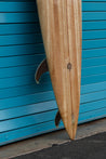 An angeled close-up of the pointed tail reveals two of the three glass-on wooden fins, as well as a glass-on leash attatchment. 