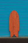 Wooden paipo surfboard with an iwa bird, the signature of shaper Chris Miyashiro, engraved at the bottom. The tail of body board looks like a fancy fish tail, called swallow sting. This board is completed with a red finish to give it a warm, cherry-like color.