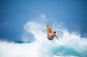 Harley Courts smacks the lip of an exploding wave, displaying the aggressive maneuvers possible to perform with this wooden fish surfboard.